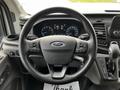 Steering wheel of a 2020 Ford Transit with various control buttons and a gear shift lever visible