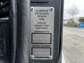 A metal identification plate featuring specifications and certification details for a 2009 Spartan Gladiator vehicle