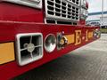 A close-up of the front section of a 2009 Spartan Gladiator fire truck featuring chrome details and equipment including lights and vents