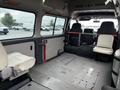 A 2002 Nissan Van interior showing a spacious cargo area with minimal seating and metal floor plates