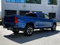 A blue 2021 Chevrolet Colorado with a double cab and a Z71 package showcasing its rear and right side