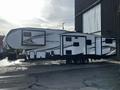 2021 Grand Design Reflection 311BHS recreational vehicle featuring a sleek white and black exterior with multiple slide-outs and large windows