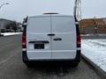 A 2019 Mercedes-Benz Metris van viewed from the rear featuring a white exterior and a rear door design with the brand logo displayed