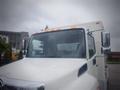 Front view of a white 2014 Hino 308 box truck showing the windshield side mirrors and orange lights on the cab roof