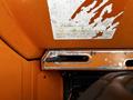 Close-up of a worn gearshift panel from a 2001 Agco ST40 tractor with visible markings and a shift lever slot