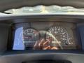 The dashboard of a 2013 Isuzu NPR showing speedometer fuel gauge tachometer and odometer readings