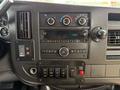 Dashboard of a 2020 Chevrolet Express featuring audio system controls air conditioning knobs and various buttons including shift lock