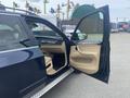 A 2009 BMW X5 with an open front door revealing a beige interior and dashboard featuring controls and a gear shifter
