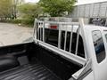 A 2012 GMC Canyon pickup truck with a metal headache rack installed in the truck bed
