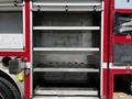 Interior storage compartments of a 2006 Emergency One Fire Truck with multiple shelves for equipment and tools