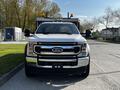 A 2021 Ford F-550 truck in white with a chrome front grille and a large bumper visible from the front