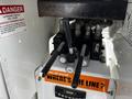 A control panel featuring levers and knobs labeled for operation on a Freightliner M2 106 vehicle
