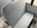 A gray plastic seat from a 2013 International 3000 bus with a smooth surface and no visible wear or damage