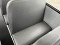 A gray bus seat with textured upholstery designed for passenger comfort in a 2007 Freightliner B2
