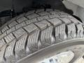 A close-up view of a tire from a 2013 Chevrolet Express showcasing its tread pattern and sidewall details