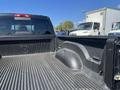 A 2011 RAM 1500 truck bed with textured black lining and a logo on the side