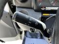 A close-up of the turn signal lever from a 2018 Hino 195 showing the various setting options for lights and signals