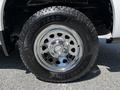 A chrome wheel with a Goodyear tire labeled Wrangler mounted on a 2021 Chevrolet Silverado 1500