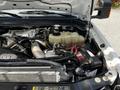 Close-up of a 2009 Ford F-550 engine bay showcasing the engine components battery and coolant reservoir