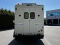A white 2009 Morgan Olson Workhorse vehicle with a flat rear end featuring double doors and a small roof light