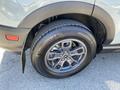 Close-up of a 2023 Ford Bronco Sport wheel featuring a sleek five-spoke design with a black finish and a Continental tire