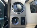 Interior dashboard controls of a 2008 Ford F-550 featuring knobs for air conditioning and lights