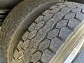 Close-up of a tire from a 2005 Volvo VND 122 showing worn tread patterns and visible signs of use on the rubber surface