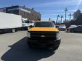 Front view of a yellow 2013 Chevrolet Silverado 1500 with a black grille and bowtie emblem