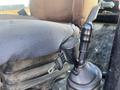 A close-up view of the joystick control and seat of a 2013 JCB 510-56 Loadall with a focus on the textured seat and control lever