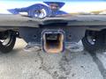 A close-up view of the tow hitch on a black 2017 RAM 1500 showing the hitch receiver and bolts
