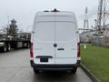 A white 2019 Mercedes-Benz Sprinter van viewed from the rear showcasing its tall design and the logo on the back door