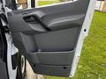The image shows the door interior of a 2017 Mercedes-Benz Sprinter featuring a gray panel with a handle and a storage compartment