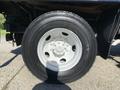 Close-up of a tire from a 2007 International 7300 with a white rim showing tread and bolt pattern