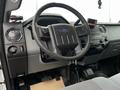 Interior view of a 2015 Ford F-550 focusing on the steering wheel dashboard controls and gear shift