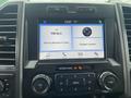 2019 Ford F-150 dashboard display with touchscreen showing FM radio station and options for connecting a phone and accessing apps