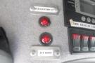 Control panel of a 2012 Mercedes-Benz Sprinter featuring two red indicator lights and several switches for various functions