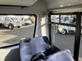 Interior view of a 2018 Chevrolet Express with blue seating and large side windows