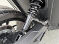 Close-up of the rear suspension system and tire of a 2020 Polaris SlingShot showcasing the shock absorber and wheel details