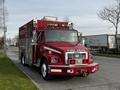 A red 1994 Freightliner FL80 fire truck with "FIRE DEPT" written on the front and a rescue compartment on the side