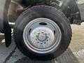 A close-up of a tire from a 2011 Ford F-450 SD featuring a silver rim with eight lug nuts and the Continental brand name on the sidewall