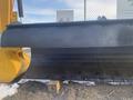 A large 12-foot plow attachment with a smooth metal blade designed for snow removal mounted on a yellow machine