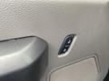 Close-up of a grey door panel from a 2017 Ford F-550 featuring a power lock switch and speaker grille