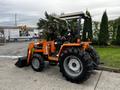 A 2001 Agco ST40 tractor in orange and gray with large black tires and a front loader attachment