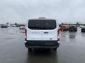 A white 2017 Ford Transit van is shown from the rear with the model name and logo visible on the back doors