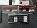 A 2009 Spartan Gladiator vehicle with multiple warning labels detailing vehicle height, length, weight ratings and maintenance specifications