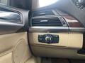 Close-up of the control panel in a 2009 BMW X5 showing air vents and a dial for headlight settings