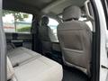 Interior view of the back seats in a 2020 Ford F-350 showing two rear seats with gray fabric upholstery and a center armrest