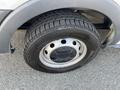 A close-up view of the wheel and tire of a 2016 Ford Transit showing the tread pattern and rim design