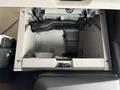 A black air intake duct located inside a storage compartment of a 2022 Freightliner Cascadia truck