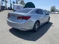 A silver 2017 Acura TLX with a sleek design featuring a curved rear and modern alloy wheels